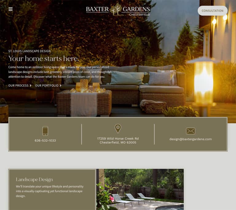 Outdoor living space with a landscaped patio, seating area, and warm garden lighting at dusk.